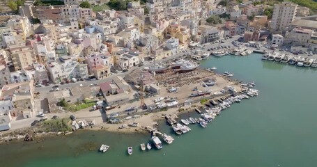 Aerial view of a small seaside village. The houses are located on the waterfront of Sciacca, in the province of Agrigento, Sicily, Italy. It overlooks Mediterranean Sea.