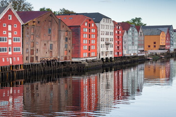 Old wooden houses on stilts line the old harbor in Trondheim, Norway