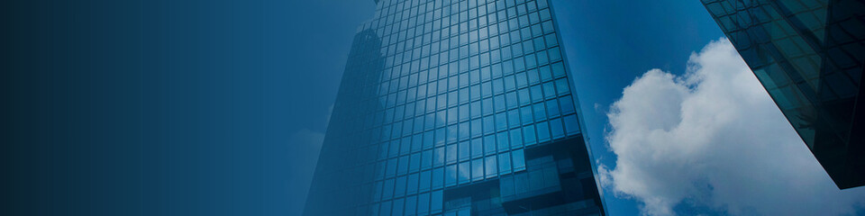 Modern glass skyscraper reflecting bright blue sky and clouds, creating a professional corporate business background ideal for finance, real estate, and commercial branding.