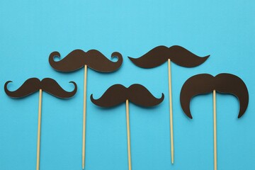 Mustache party props funny facial hair accessories on blue background concept
