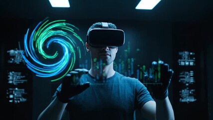 Male IT professional wearing VR headset and haptic gloves interacting with a futuristic user interface displaying charts and data - Powered by Adobe