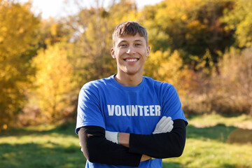 Fototapeta premium Environment protection. Happy young volunteer in park