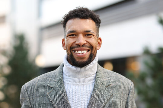 Portrait of smiling man in suit on city street - Powered by Adobe