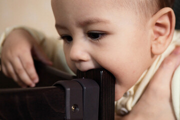 Cute adorable newborn baby playing with colorful rattle toy. baby with teether. six months old...