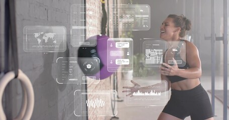 Striking athlete in black sportswear hitting purple rebound ball in gym with AR panels, copy space