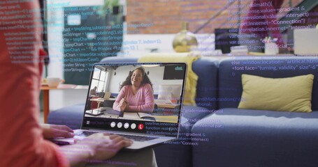 Typing hands in red long-sleeve tapping laptop at home, showing woman in pink sweater, code overlay