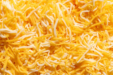 Close up macro of grated shredded cheese blend of Colby and Monterey jack cheeses