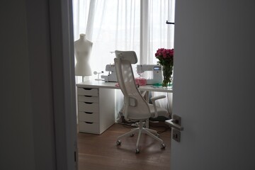 Sewing Workspace with Machine, Overlock and Flowers	, sewing room