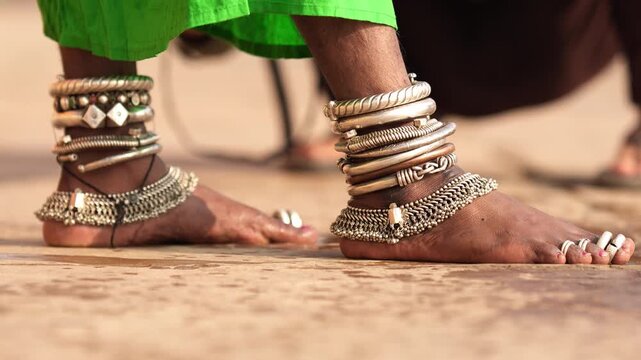 Close-up of Indian woman&rsquo;s feet adorned with silver anklets and traditional jewelry, representing the elegance of Indian cultural heritage.