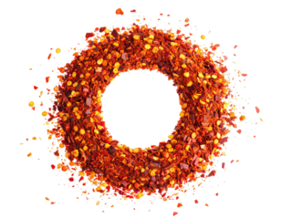 Circular arrangement of red pepper flakes, showcasing texture and vivid color against black