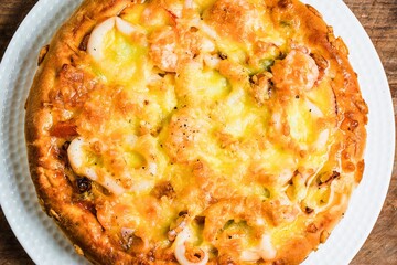 Golden brown savory omelette topped with melted cheese and vegetables