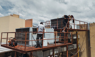 Industrial air conditioning repair technicians at work