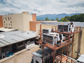 Industrial air conditioning repair technicians at work