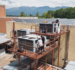 Industrial air conditioning repair technicians at work