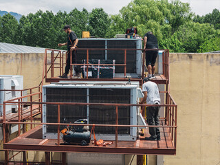Industrial air conditioning repair technicians at work