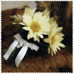 Bouquet of white daisies with a ribbon on a wooden surface, showcasing natural beauty and simplicity