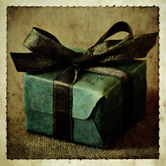 Wrapped gift with black ribbon on textured background creates a warm, inviting atmosphere