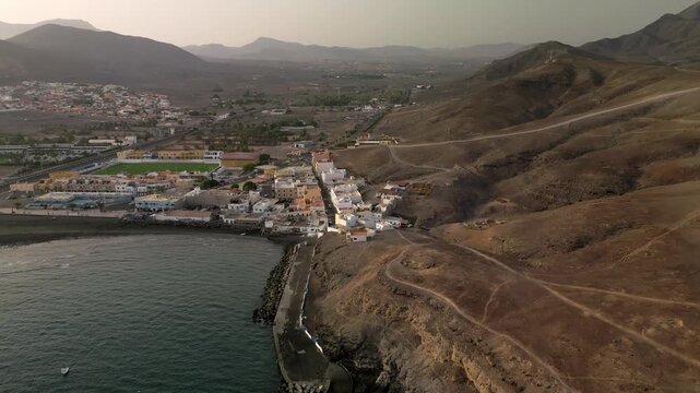 Aerial view of the Tarajalejo, town situated on the slopes of volcanic coast of the southern part of the Fuerteventura Island, Canary Islands, Spain.