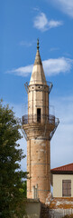 Historic minaret tower against blue sky in Crete
