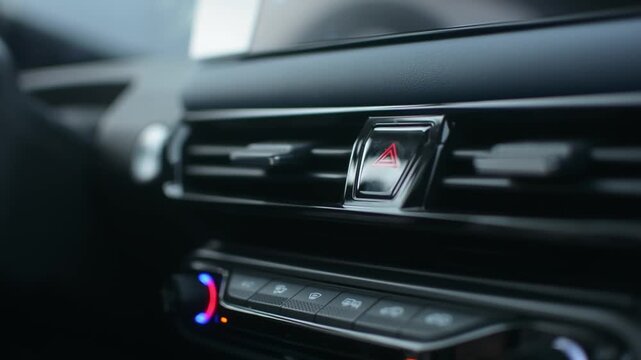 Driver presses hazard warning light button to activate and then deactivate emergency lights, demonstrating quick safety response.