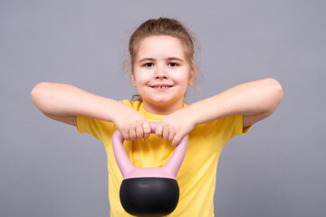 Sport for kids with kettlebell workout isolated studio portrait. Fitness for kids muscles. Power child kettlebell training. Motivation and health kid. Kid kettlebell lifting. Child kettlebell sport.