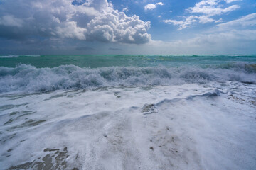 Sea beach background. Blue sea beach waves. Sandy sea beach shore. Sea beach ocean view. Summer sea beach scene.