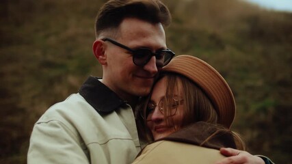 Romantic young couple hugging, talking, and kissing outdoors in a scenic autumn landscape - Powered by Adobe