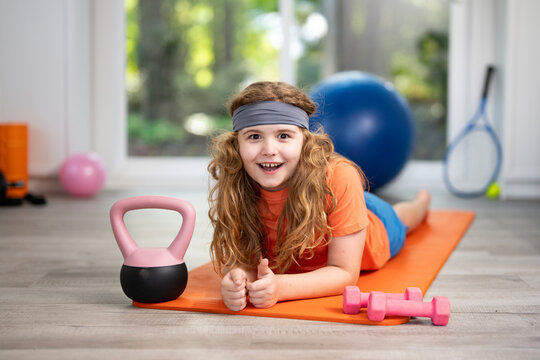 Child doing sport fitness at home. Little boy exercising at home. Kid practicing fitness at home. Child stretching body for healthy lifestyle. Child enjoying sport fitness at home. Child workout in