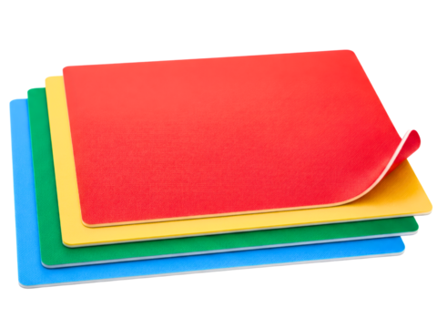 Four color-coded flexible chopping mats for food preparation safety on a transparent background
