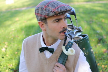 Golfer smoking from a pipe 