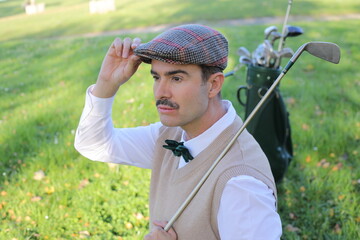 Golf player adjusting his hat during a sunny day 
