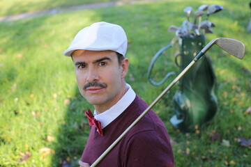 Handsome elegant golfer with a mustache 