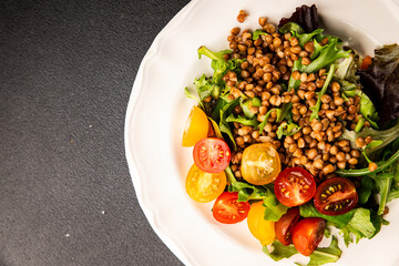 Lentil salad vegetables, tomato, green leaf lettuce tasty snack fresh delicious gourmet food table setting rustic top view copy space keto and paleo diet vegetarian and vegan food