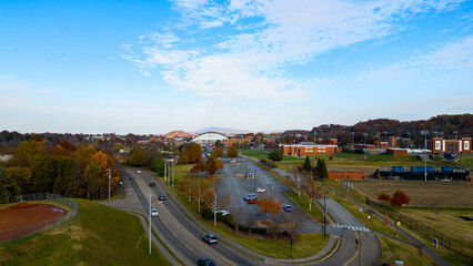 Slow moving cars on a road in town during the fall 