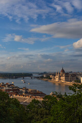 Fototapeta premium Left bank part of Budapest with River Danube on a foreground and Hungarian Parliament Building in center, view from Castle Hill at sunny evening