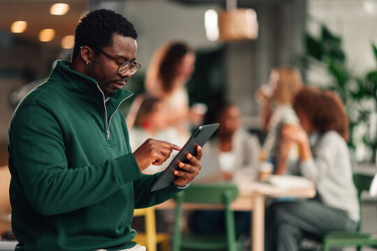 Focused man using digital tablet in office