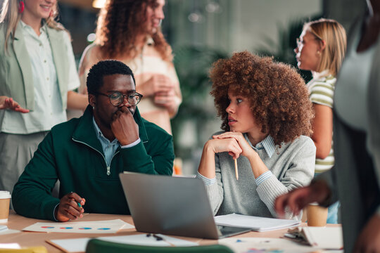 Diverse colleagues collaborating brainstorming ideas in modern office