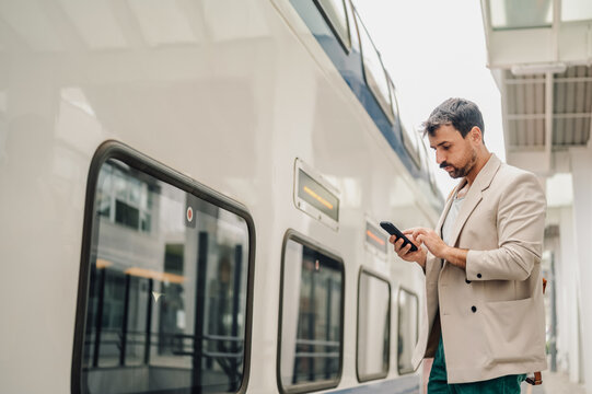 Man using smartphone waiting for public transport