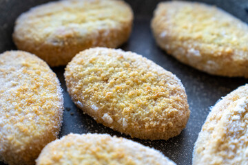 frozen cutlets in a frying pan, semi-finished product