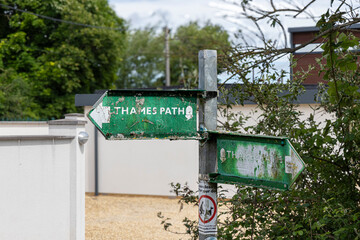 Weather beaten Thames Path sign near Cricklade, North Wiltshire.  The Thames Path is one of a number of National Trails arpound England and Wales in the United Kingdom.