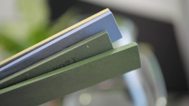 Multicolor Knife Sharpening Stones Close Up with Grinding Sound, Blade Contact Detail, Hand Motion Precision, Culinary Tool Maintenance Action, Edge Preservation, Kitchen Knife Efficiency, Close Up Wo