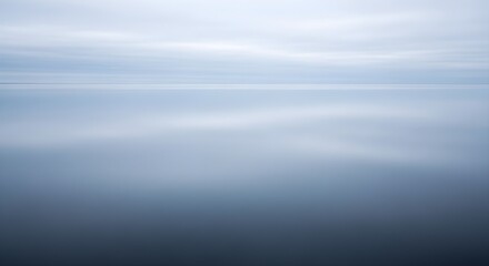 Calm water reflecting overcast sky minimalist landscape background