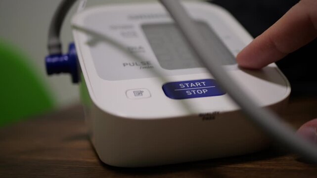 Digital Home Blood Pressure Monitor Measuring Patient Arterial Pressure Automatically, Hand and Arm Placement Detail, Family Health Monitoring Action, Accurate Medical Device Function, Household Welln