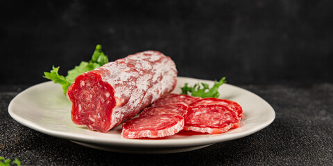 Dry sausage slice pork less fat jamon cured meat natural product tasty snack fresh delicious gourmet food background on the table rustic top view copy space