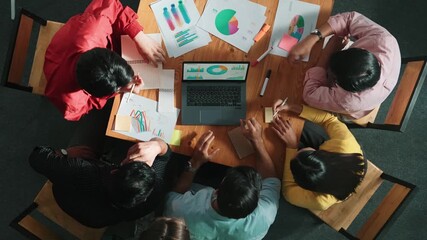 Top view of business team looking at laptop and analyzing chart. Close up of diverse group working on computer and reading financial report. Group of people explain idea at meeting. Convocation. - Powered by Adobe