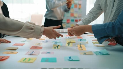 Group of diverse professionals engaged in a creative brainstorming session with colorful sticky notes, emphasizing teamwork and innovative ideas during a meeting. SACTR - Powered by Adobe