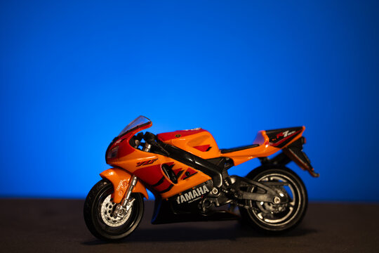 Bucharest Romania 10 November 2025.Toy Yamaha R7 motorcycle on a blue background. Miniature sport bike model representing speed, power, and design. Close-up studio shot with clean blue surface 