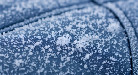 Obraz premium Frosty texture on blue surface with snowflakes in winter 