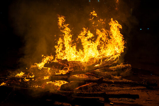logs on fire for the hindu festival of holi lohri or a cremation pyre showing the celebration of this harvest festival across India
