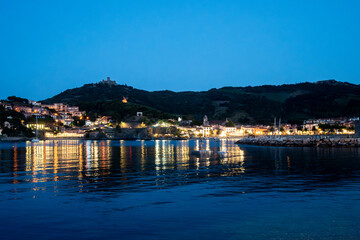 Night view on sea bay, lights and colourful houses of Collioure, Cote Vermeille, Pyrenees-Orientales, Occitania, France. Summer vacation destination